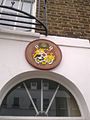 Plaque above the entrance depicting the Coat of arms of Tonga