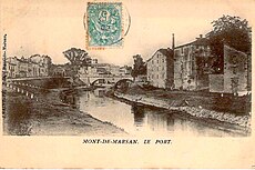 Carte postale ancienne du quartier du port. A droite, vue sur les entrepôts et le quai de la Midouze. En arrière-plan, vue sur le pont du Commerce, construit en 1869. A gauche, le quai Silguy et le chemin de halage.