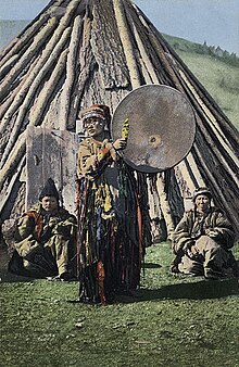 Russian postcard based on a photo taken in 1908 by S. I. Borisov, showing a female shaman, of probable Khakas ethnicity. SB - Altay shaman with drum.jpg