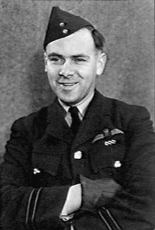 Informal half portrait of man in dark military uniform wearing forage cap