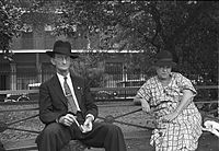 Scéna na Jackson Square, New Orleans, Louisiana, 1935; fotografie muže a ženy středního věku, sedící na lavičce v parku.