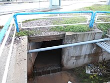 A storm drain culvert under the main road empties into a bigger open channel StormDrainCulvert.JPG