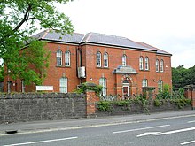 Colour photograph of a 19th-century utilitarian red-brick building with a slate roof.