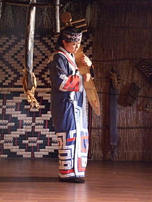 Woman playing a tonkori
. Woman playing traditional Ainu instrument.jpg