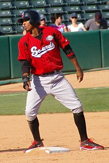 A baseball player in red and gray