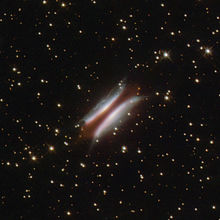 Gomez's Hamburger, with the bright "buns" being the scattered light of the star on the surface of the disk. The reddish dark "patty" represents the mid-plane of the disk. Gomez's Hamburger.jpg