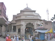 Chief (eastern) entrance of the temple, with houses the "Namdeva chi Payari". The small blue temple in front of the gate is saint Chokhamela's memorial.
