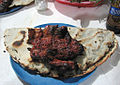 A traditional Tlayuda served folded and topped with a slice of beef skirt-steak. Oaxaca, Oaxaca, Mexico