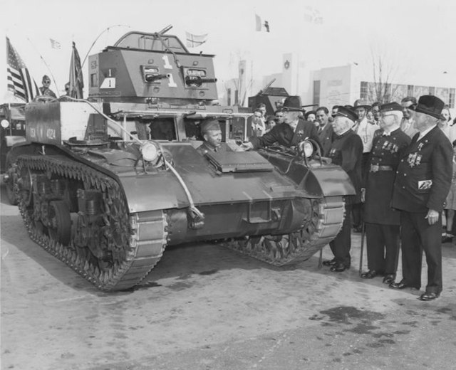 Army veterans inspect an M1 combat car at the 1939 World's Fair in New York