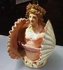 Pottery vessel in the shape of Aphrodite inside a shell; from Attica, Classical Greece, discovered in the Phanagoria cemetery, Taman Peninsula (Bosporan Kingdom, southern Russia), 1st quarter of 4th century BC, Hermitage Museum, Saint Petersburg. Atuell en forma d'Afrodita en una petxina, Atica, necropolis de Fanagoria, pininsula de Taman. Primer quart del segle IV aC, ceramica.JPG