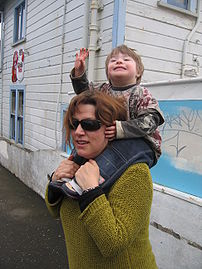 A child riding piggy-back.