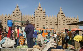 Mercat central de Djenné amb la figura emblemàtica dels tres minarets de la gran mesquita al darrere