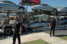 Police guarding cars destined for destruction from "Don't Crush Campaign" protestors (2005) EV1 dont crush protest 692.jpg