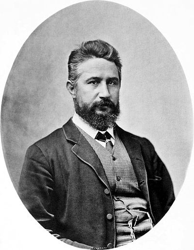 Portrait of John William Lindt: Oval black-and-white photograph of a middle aged man with a mid-length beard, waistcoat and jacket.