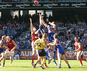 Players contest the ruck in an AFL match betwe...
