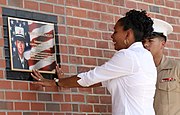 Elida Nunez examines a memorial plaque to her daughter in June 2007.