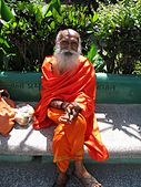 3. A Yoga instructor in Rishikesh sitting on a bench with a bag of groceries. Love his hands.