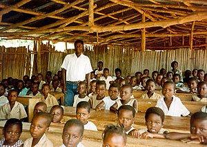 Teacher with students in Benin classroom