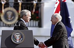 Photograph of U.S. President George W. Bush shaking hands with Australian Prime Minister John Howard, during the State Arrival Ceremony held for the Prime Minister on the South Lawn of the White House, May 2006