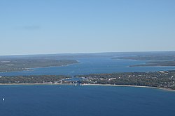 Aerial view of the town from above Lake Michigan; the small lake in the center is Round Lake and the larger one in the background is Lake Charlevoix.