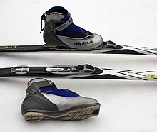 Cross-country ski boot and standardized binding system for classic skiing. The skier clicks the toe of the boot into the binding and releases with the button in front of the boot. Cross-country ski boot and binding system--Classic.jpg