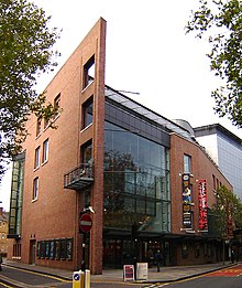 exterior of modern theatre building in red brick and glass