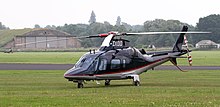 An AW109E parked on the grass G-DIDO - AgustaWestland AW109 (27888205767).jpg