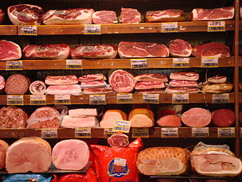 Meat counter: Prosciutto (top two rows), salam...