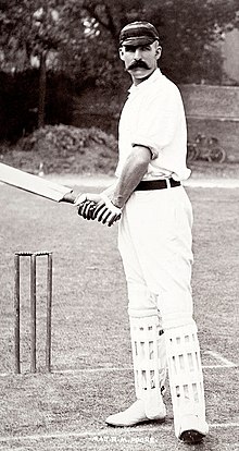 A black and white picture of a cricketer holding a cricket bat