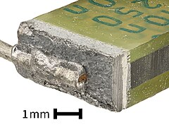 Close-up of schoopage and terminal of stacked film capacitor