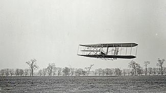 Orville in flight over Huffman Prairie in Wright Flyer II. Flight #85, approximately 1,760 feet (536 m) in 40 1/5 seconds, 16 November 1904.