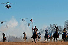 The 1st Cavalry Division's combat aviation brigade performing a mock charge with the horse detachment 1 CAV DIV charge.jpg