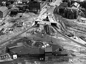 An aerial view of a roundhouse and a two-pronged tunnel under construction