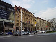 Front of the Slovak Ministry of Culture building housing the Astorka Korzo '90 Theatre from a street view, with cars parked in front