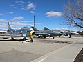 A static display of a North American F-86A Sabre (replica), a MiG-21 (originally Polish, but in Soviet livery here), and a McDonnell-Douglas RF-4C Phantom.