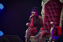 Jessie J performing at the 2011 The Big Chill, sitting on the "gilded throne" she used for performances while her foot was broken. Jessie J - Big Chill 2011.jpg