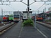 A variety of electric and diesel powered trains at Komagawa station in 2003