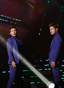 Image of the members dressed in blue suits
