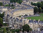 An aerial view of a semicircular terrace of houses.