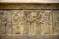 Shalmaneser III greets Marduk-zakir-shumi, detail, front panel, Throne Dais of Shalmaneser III at the Iraq Museum