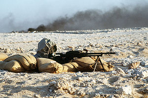 English: A Syrian soldier aims a 7.62mm PKM li...