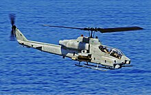 A Super Cobra flies past USS Fort McHenry during a Search and Seizure (VBSS) drill in 2009. US Navy 090609-N-5345W-008 An AH-1W Super Cobra from the Thunder Chickens of Marine Medium Tiltrotor Squadron (VMM) 263 performs a low-altitude surveillance pass during a Visit, Board, Search and Seizure (VBSS) drill.jpg