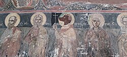 Τοιχογραφία από το Ναό των Αγ. Αναργύρων, εντός του νεκροταφείου του Αντρωνίου Ηλείας. Ο Άγιος Χριστόφορος ο Ρέπροβος, απεικονίζεται με κεφάλι σκύλου (στη μέση), κρατώντας στο δεξί του χέρι έναν σταυρό.