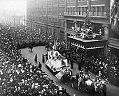 Eaton's Santa Claus Parade, 1918, Toronto, Canada. Having arrived at the Eaton's department store, Santa is readying his ladder to climb up onto the building. 1918eatonssantaclausparade.jpg