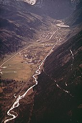 Aerial view of newly cut Boomerang Road (May 1972). AERIAL VIEW OF TELLURIDE SHOWING NEWLY-CUT SKI TRAILS (IN RIGHT FOREGROUND - NARA - 543746.jpg