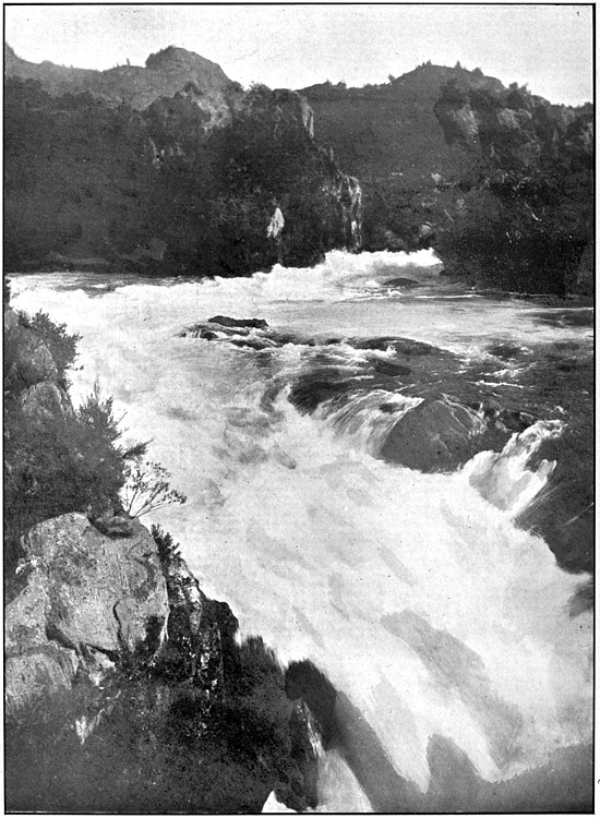 River with rapids surrounded by hills and bush