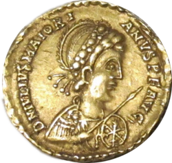 Golden coin depicting man facing right, wearing military garb and wielding a spear and shield