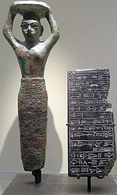 An architectural foundation-nail figurine depicting king Amar-Sin himself carrying the builder's wicker traybasket. His name translates to 'immortal moon-god'. P1150892 Louvre figurine-clou-Ur AO3142 rwk.jpg