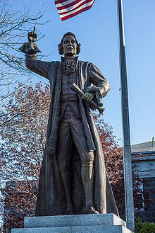 Bronze sculpture of James Otis, Jr stands in front of the Barnstable County Courthouse. Statue of James Otis Jr in Barnstable.jpg