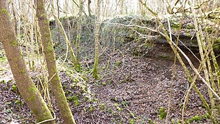 A truncated slag mound shows its layers